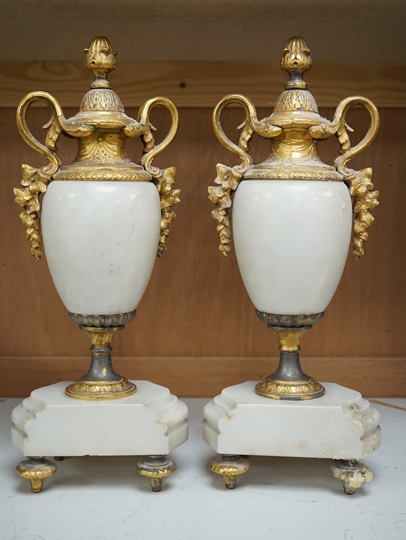 A pair of early 20th century white marble and gilt metal garnitures, 32cm. Condition - worn